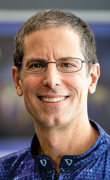 A man wearing glasses and a blue shirt