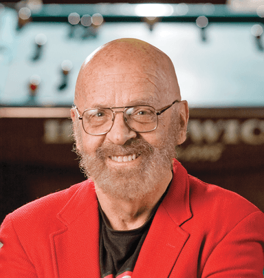 A man with a beard wearing a red jacket