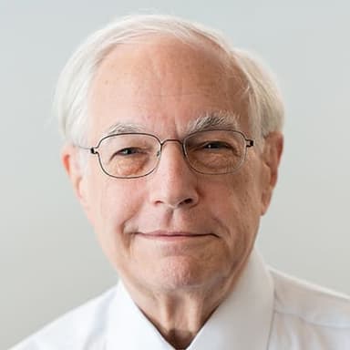 An older man wearing glasses and a white shirt
