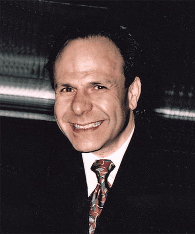 A smiling man in a suit and tie