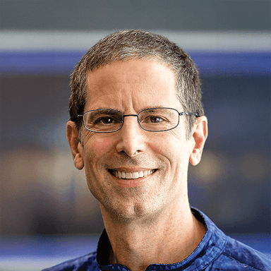 A man wearing glasses and a blue shirt